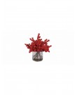 Red holly berries in glass jar